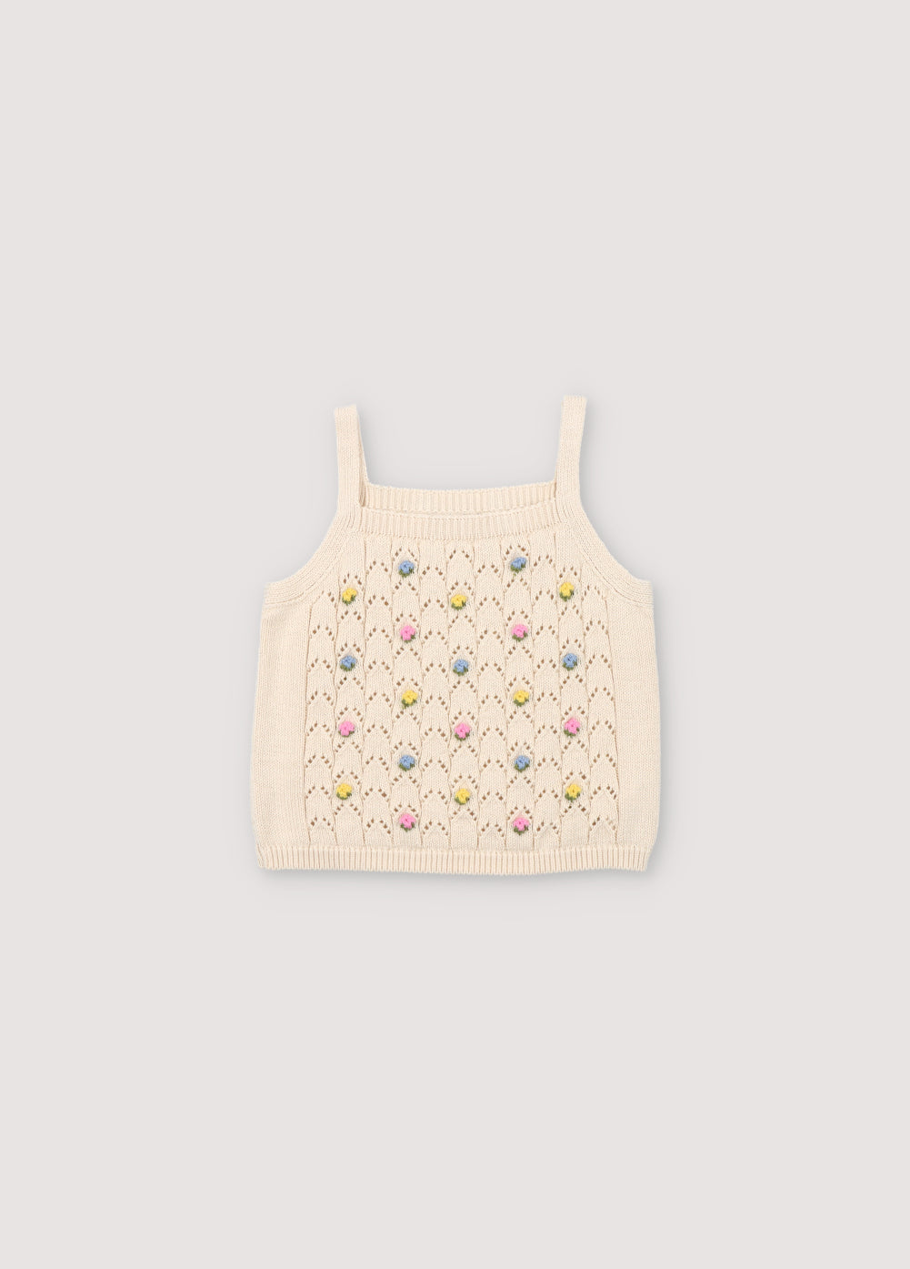 Crop-style knit top with structure and flower details. Perfect for pairing with the rest of the garments in the set.
