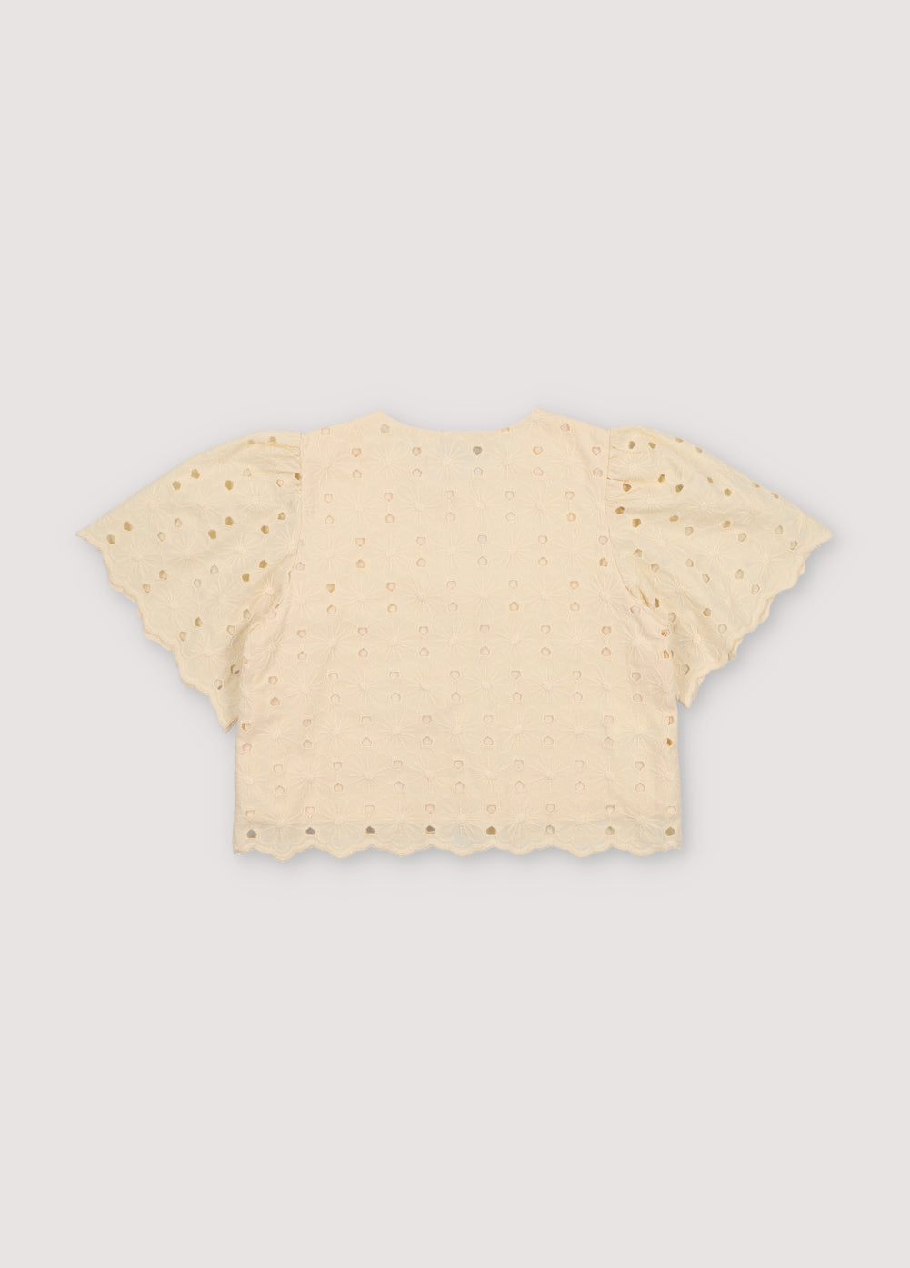 Creta Blouse in embroidered blend cotton fabric in macadamia color, featuring gathered sleeves, a high neckline, and central bow closure. New Collection Kids