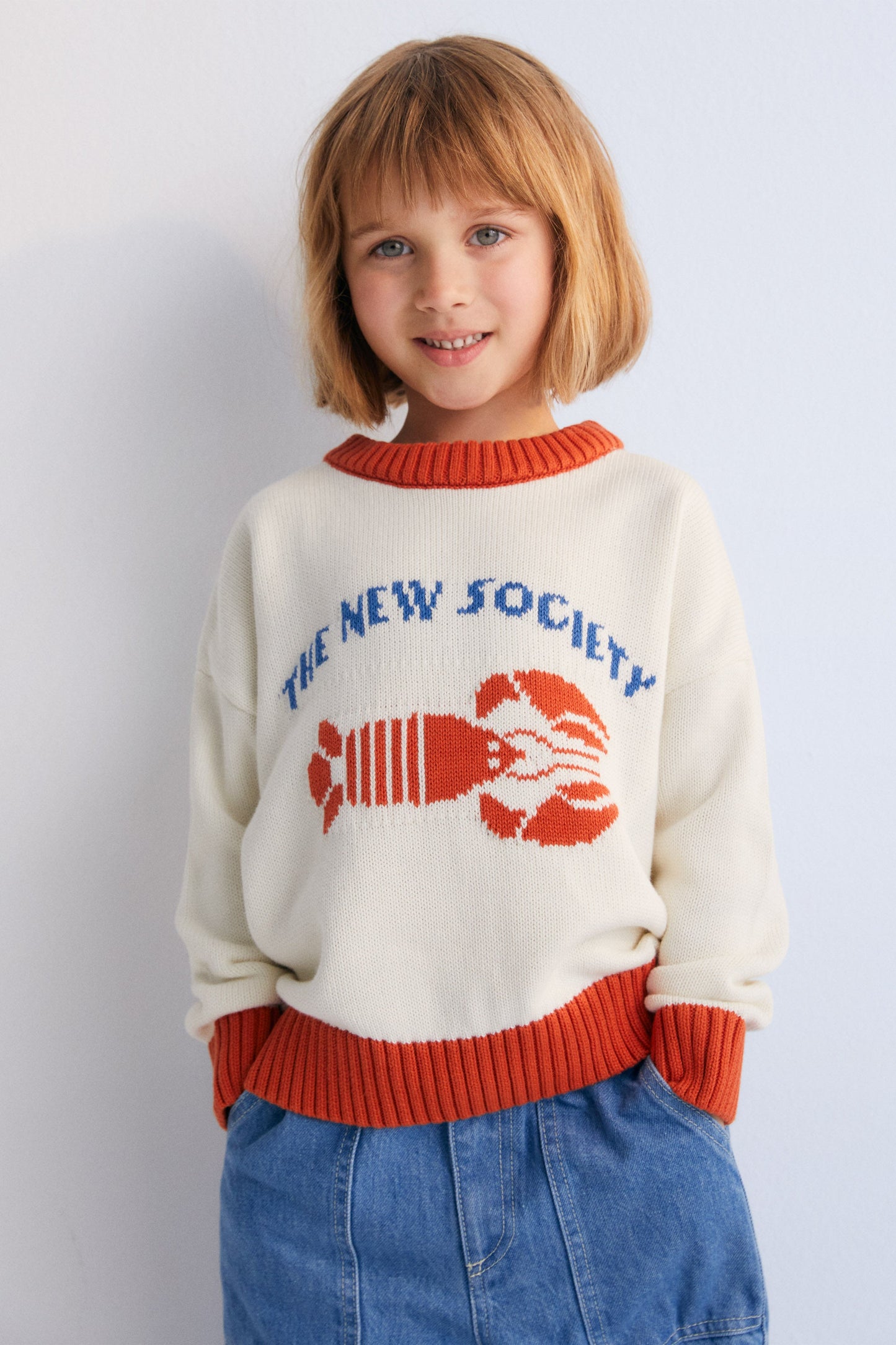 Sweater with contrast ribs on the neckline, cuffs, and hem, and our lobster jacquard on the front, making it a fun garment.