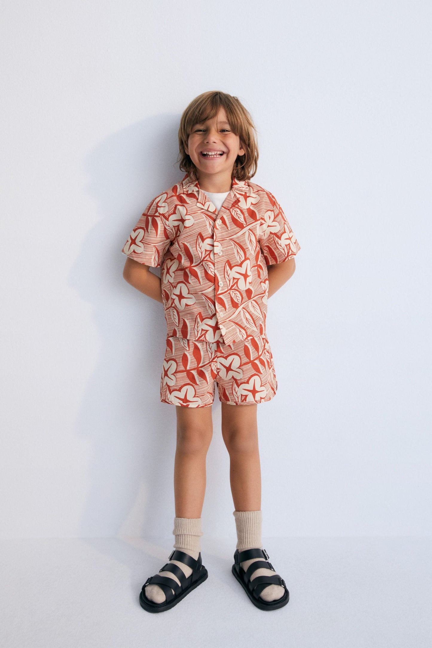 Filotis Short in 100% cotton fabric with our chili mountain rose print, featuring an elastic waistband in chili with macadamia-colored letters. Spring Summer Collection. The New Society.