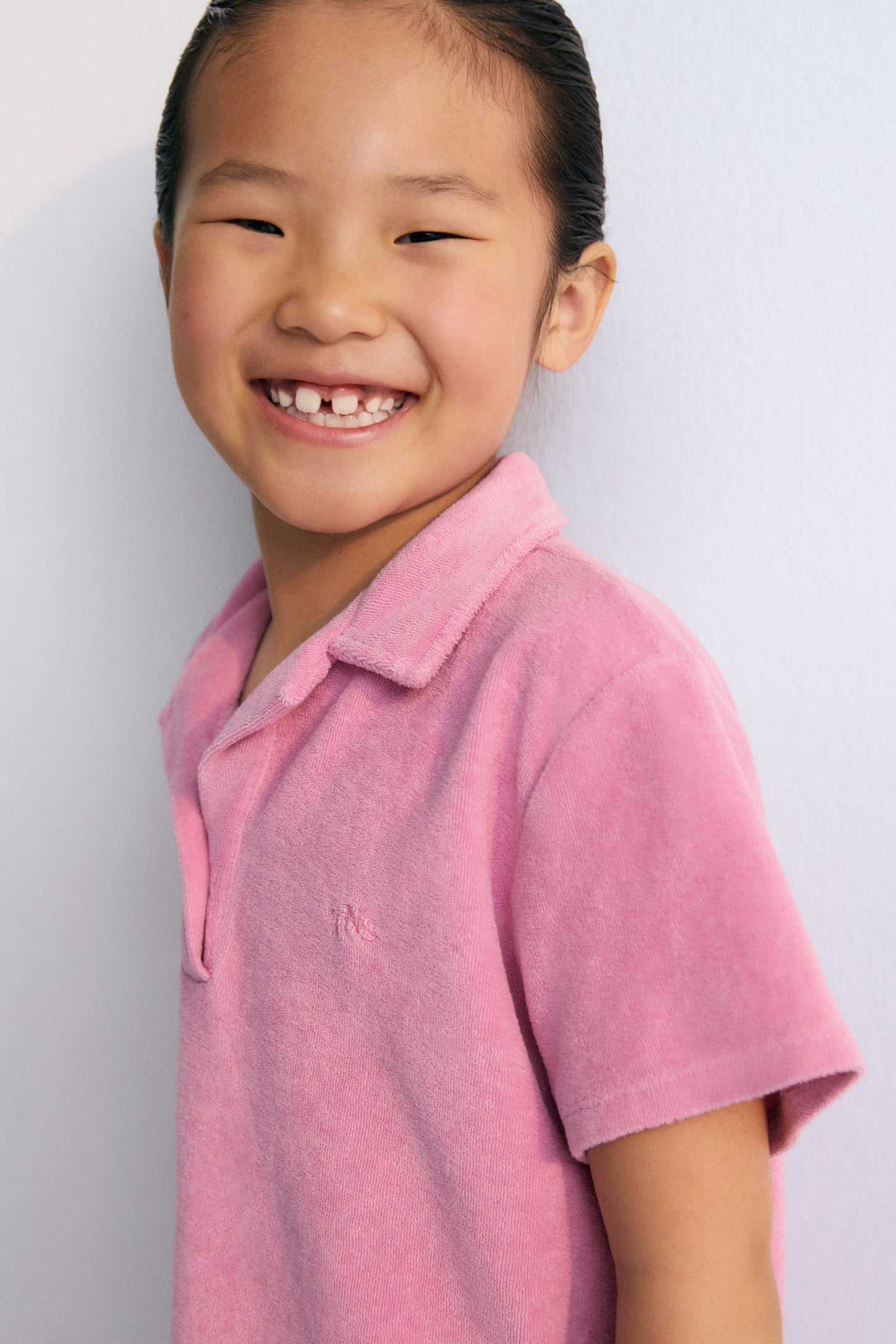 Terry fabric polo shirt with brand logo embroidery on the chest in a matching color. Perfect for pairing with the matching shorts to create a summery look. The New Society. kids collection