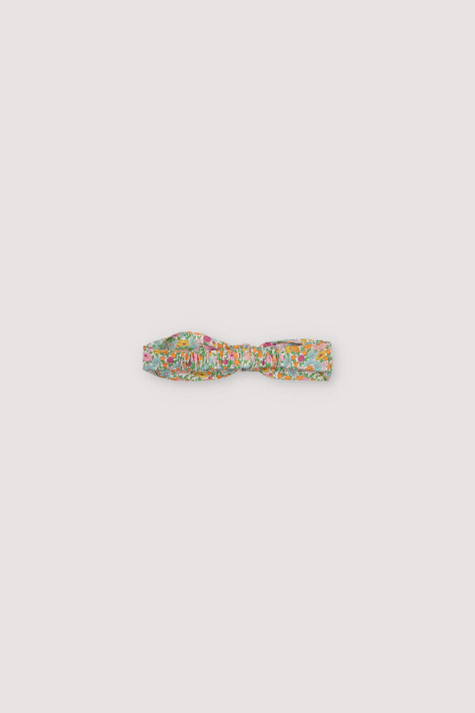 Headband with central bow and elastic band in Liberty fabric. Perfect to complete the Andreas outfit. New Collection The New Society