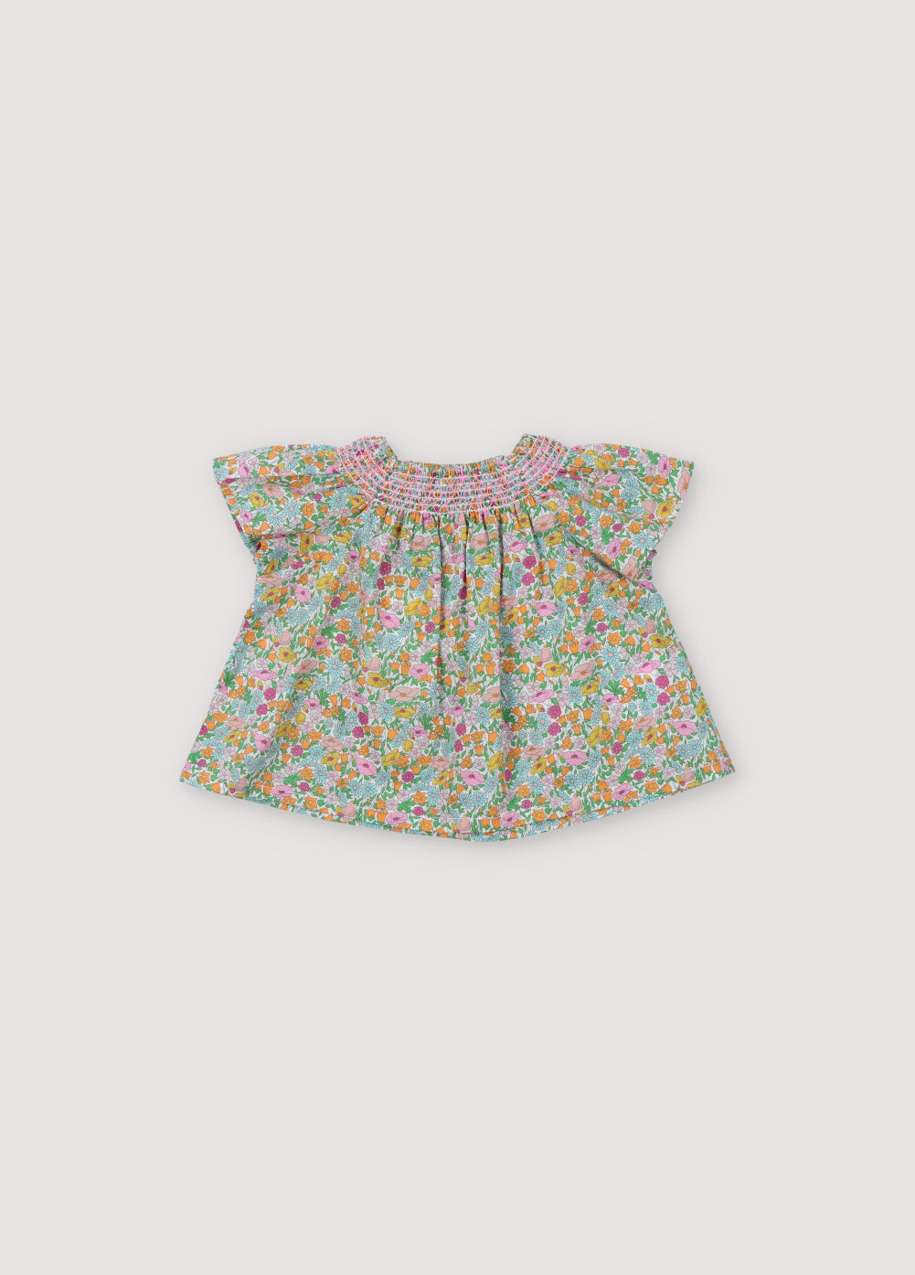 Andreas Baby Blouse in Liberty fabric, short-sleeved raglan, smoke with hibiscus-colored thread that generates volume throughout the garment. Spring Summer Collecton. The New Society.