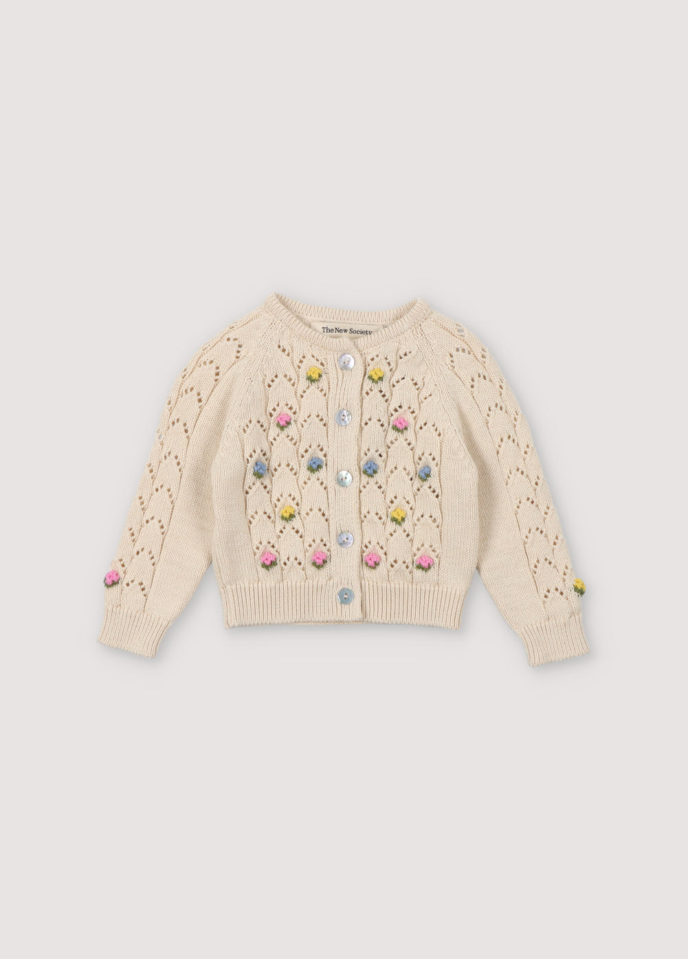 Cardigan with structure and flower details. It has a wooden button opening. Perfect to match with the bloomer and hat. Spirng Summer Collection. The New Society.