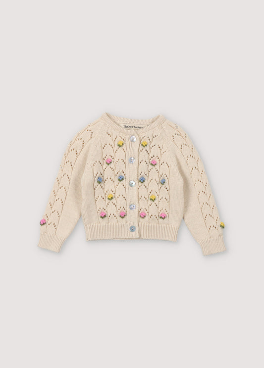 Cardigan with structure and flower details. It has a wooden button opening. Perfect to match with the bloomer and hat. Spirng Summer Collection. The New Society.
