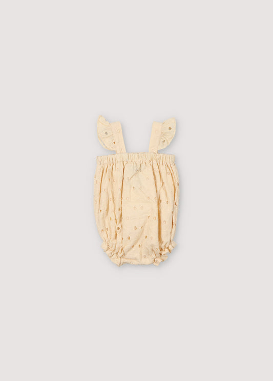 Creta Baby Romper in embroidered blend cotton fabric in macadamia color, with straps featuring ruffle details, elastic at the chest and legs with ruffle details, and snap closure in matching color. Spring Summer Collection. The New Society.