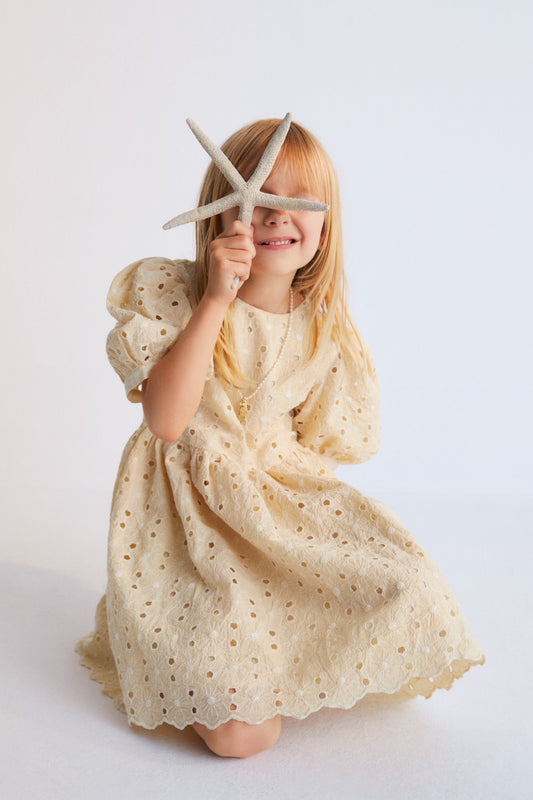Creta Dress our bestseller now with embroidered blend cotton fabric in macadamia color. Dress with puffed sleeves and a flared skirt. New Collection Kids.