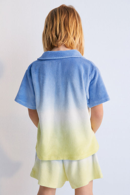 Tie-dye terry fabric polo shirt with brand logo prominently embroidered on the chest. Perfect for pairing with the matching shorts to create a summery look.
